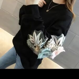 Chic Black Sweater with Floral Accents